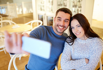 Image showing couple taking smartphone selfie at cafe restaurant