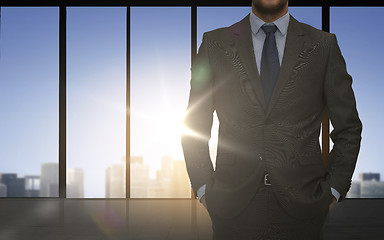 Image showing close up of business man over office background