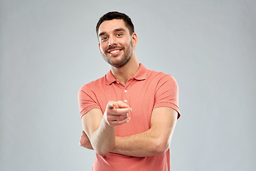 Image showing man pointing finger to you over gray background