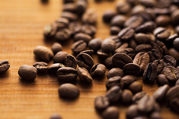 Image showing close up coffee beans on wooden table