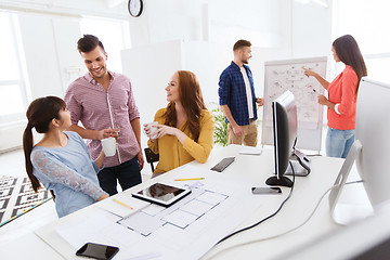 Image showing happy creative team rinking coffee at office