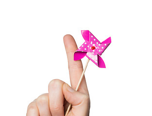 Image showing close up of hand holding pinwheel toy