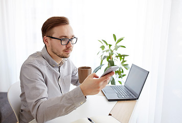 Image showing businessman with smarphone and coffee at office