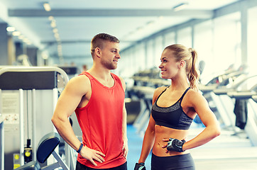 Image showing smiling man and woman talking in gym