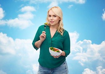 Image showing smiling young woman eating vegetable salad