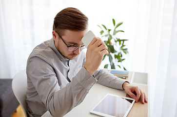 Image showing businessman with smarphone at home office