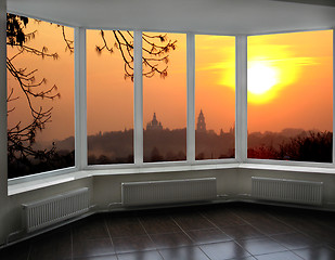 Image showing plastic windows overlooking the fiery red sunset