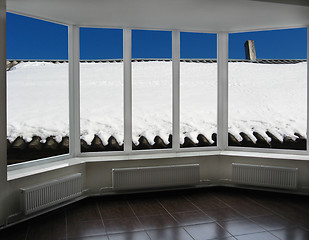 Image showing windows overlooking the snow-covered rural roof