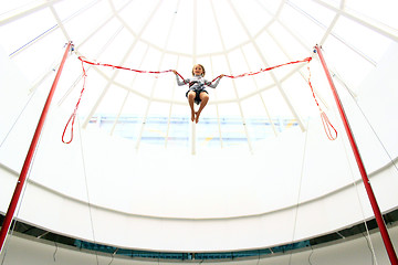 Image showing girl jumps on the trampoline