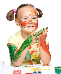 Image showing Portrait of a cute girl playing with paints