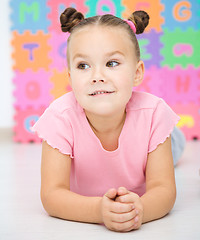 Image showing Little girl is laying on floor in preschool