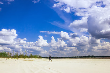 Image showing Man in  the turban walking under a cloudy sky