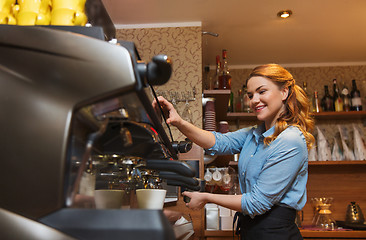 Image showing barista woman making coffee by machine at cafe