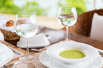 Image showing close up of soup and water glasses at restaurant