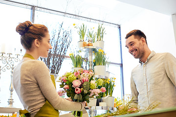 Image showing smiling florist woman and man at flower shop