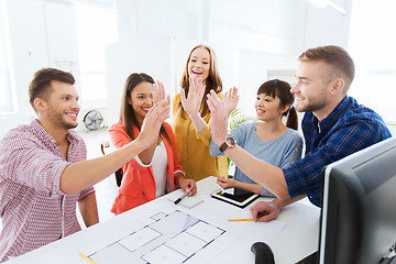 Image showing creative team making high five at office