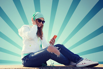 Image showing happy young woman with smartphone and headphones