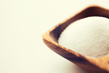 Image showing close up of white sugar heap in wooden bowl