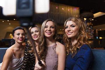 Image showing women with smartphone selfie stick at night club