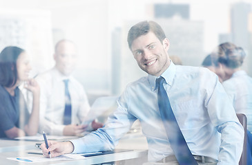 Image showing group of smiling businesspeople meeting in office