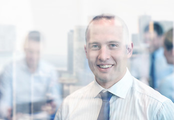 Image showing group of smiling businesspeople meeting in office