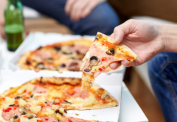 Image showing close up of friends with beer and pizza at home