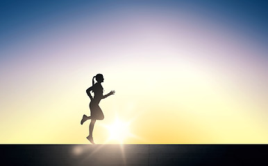 Image showing happy young sports woman running outdoors