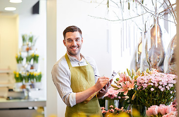 Image showing florist man with clipboard at flower shop