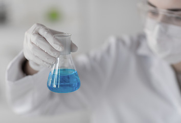 Image showing close up of woman with flask making test in lab