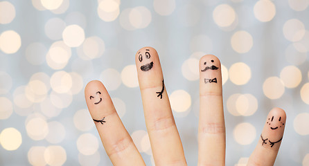 Image showing close up of four fingers with smiley faces