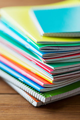 Image showing close up of notebooks on wooden table