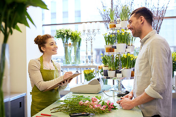 Image showing florist woman and man making order at flower shop