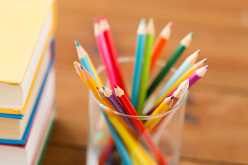 Image showing close up of crayons or color pencils and books