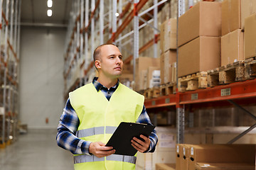 Image showing man with clipboard in safety vest at warehouse