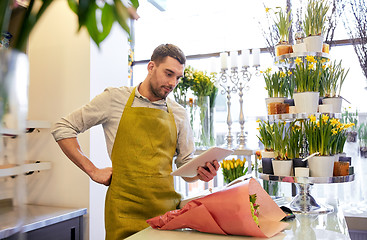 Image showing man with tablet pc computer at flower shop