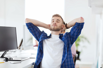 Image showing happy creative man with computer at office