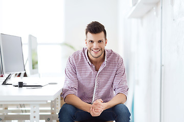 Image showing happy creative man with computer at office