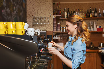 Image showing barista woman making coffee by machine at cafe