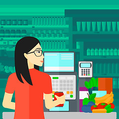 Image showing Cashier at supermarket checkout.