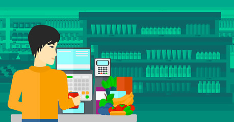 Image showing Cashier at supermarket checkout.