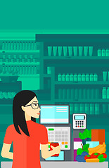 Image showing Cashier at supermarket checkout.