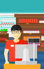 Image showing Salesman standing  at checkout.