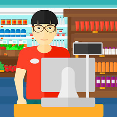 Image showing Salesman standing  at checkout.