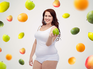 Image showing happy plus size woman in underwear with apple