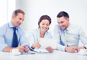 Image showing business team looking at tablet pc in office