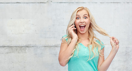 Image showing smiling young woman calling on smartphone