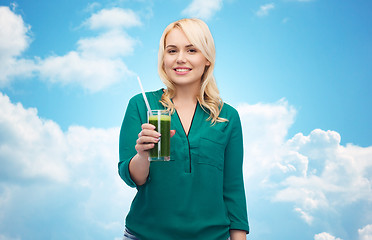 Image showing smiling woman drinking vegetable juice or smoothie