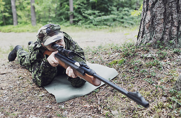 Image showing young soldier or hunter with gun in forest