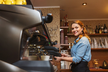 Image showing barista woman making coffee by machine at cafe