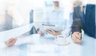 Image showing business team with graph, tablet pc and coffee